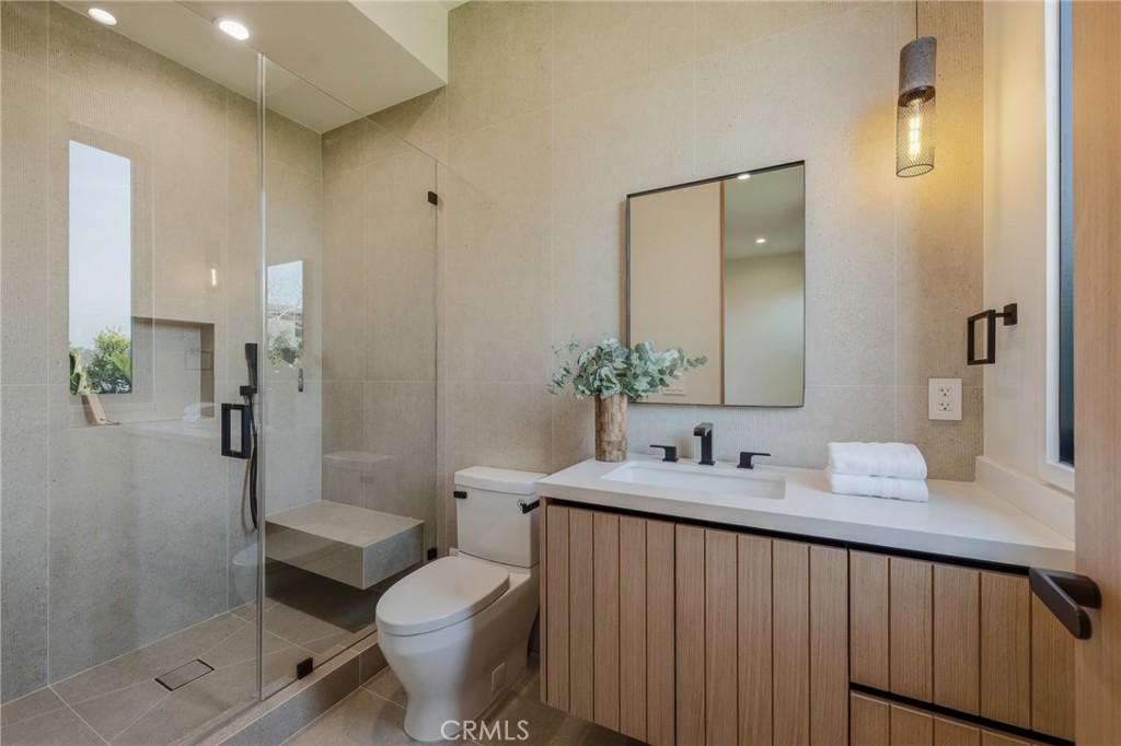 16252 Addison Street Encino, CA 91436 - Photo 19 of 36 a bathroom with a sink toilet and shower
