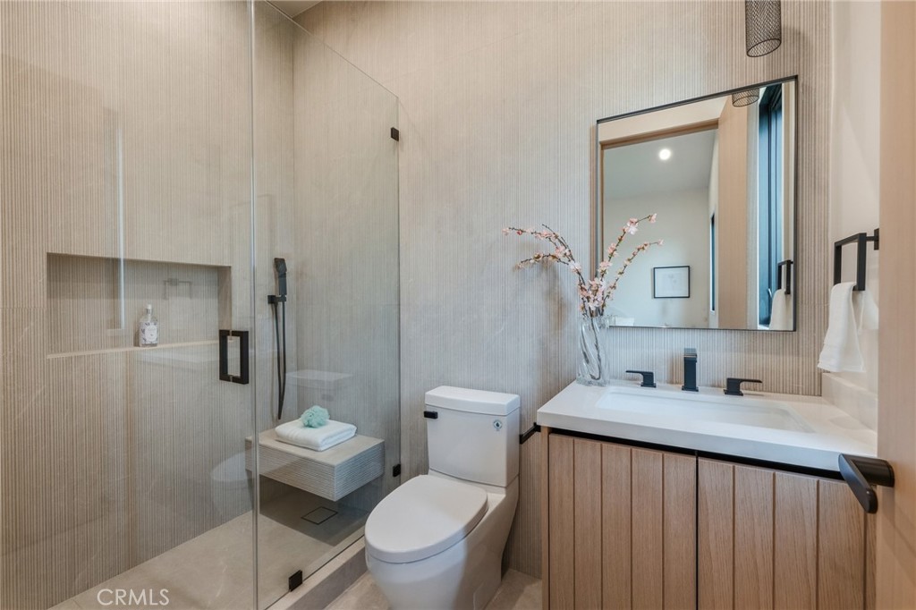 16252 Addison Street Encino, CA 91436 - Photo 21 of 36 a bathroom with a granite countertop sink toilet and shower