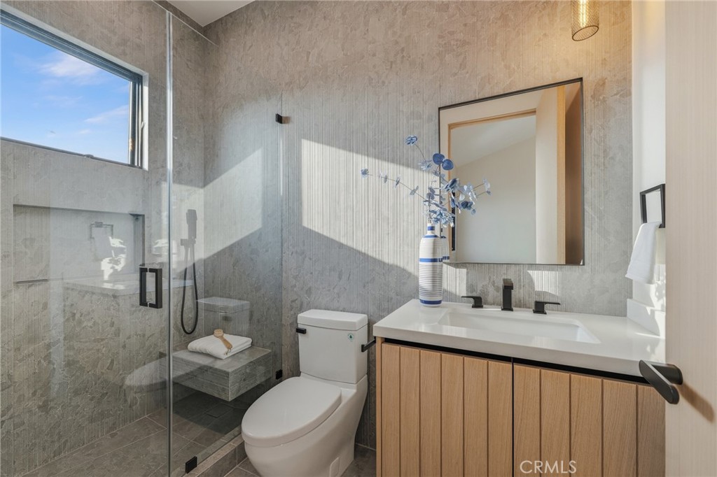 16252 Addison Street Encino, CA 91436 - Photo 23 of 36 a bathroom with a sink a toilet and mirror