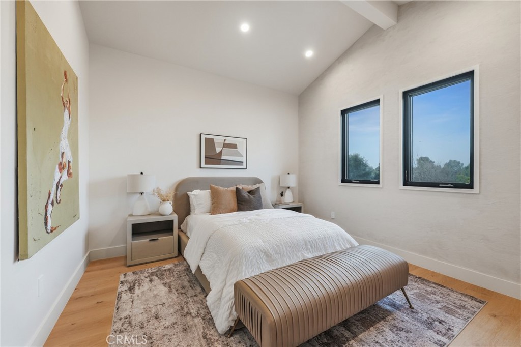 16252 Addison Street Encino, CA 91436 - Photo 24 of 36 a bedroom with a large bed and a window