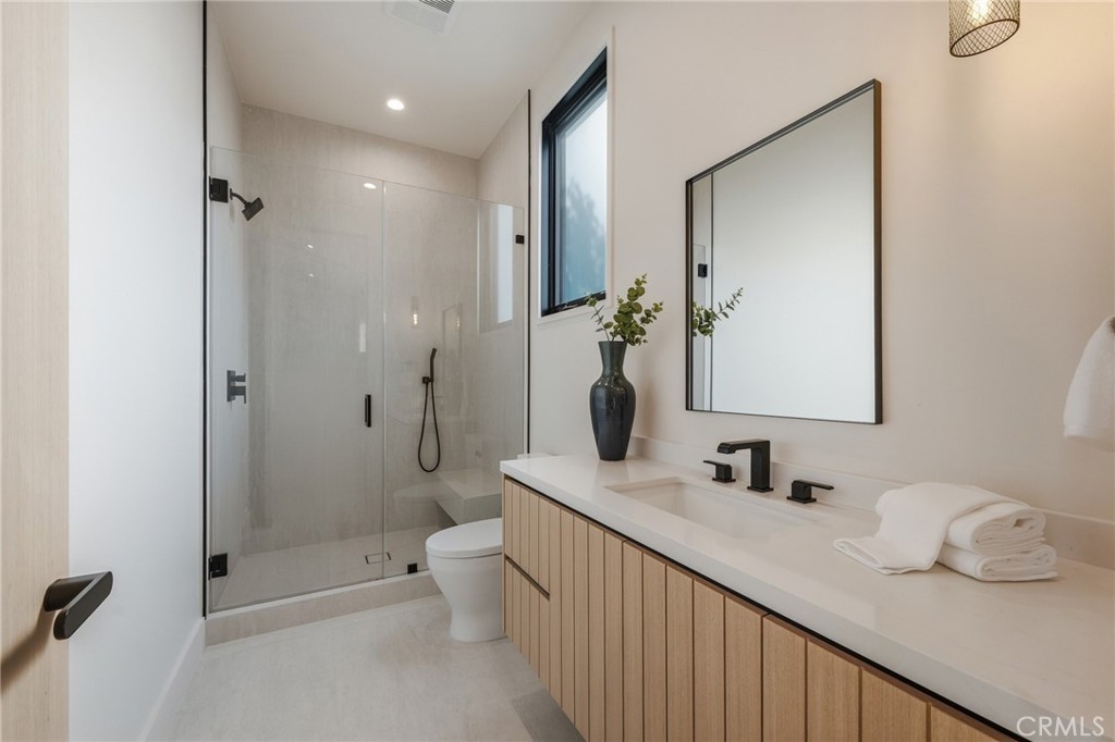 16252 Addison Street Encino, CA 91436 - Photo 25 of 36 a bathroom with a double vanity sink toilet and shower