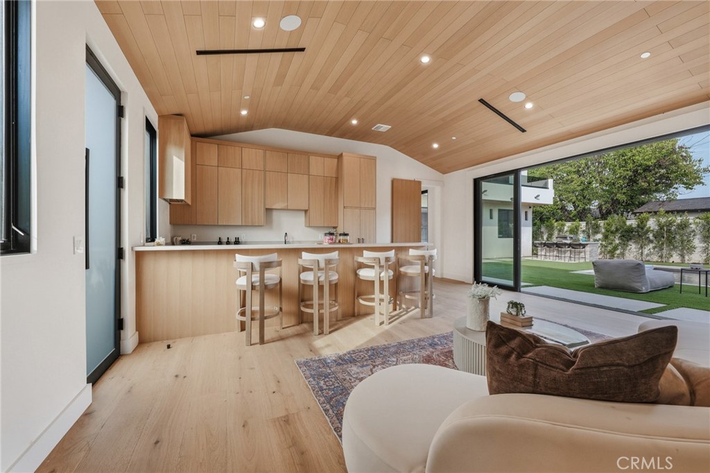 16252 Addison Street Encino, CA 91436 - Photo 33 of 36 a living room with stainless steel appliances furniture a large window and a wooden floor
