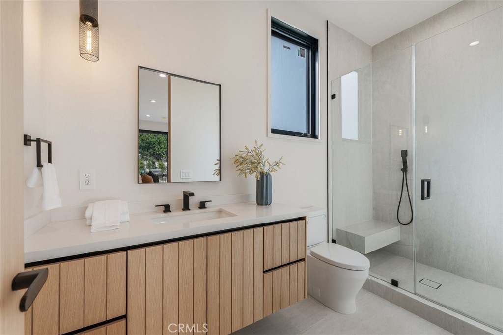 16252 Addison Street Encino, CA 91436 - Photo 35 of 36 a bathroom with a sink a toilet and shower