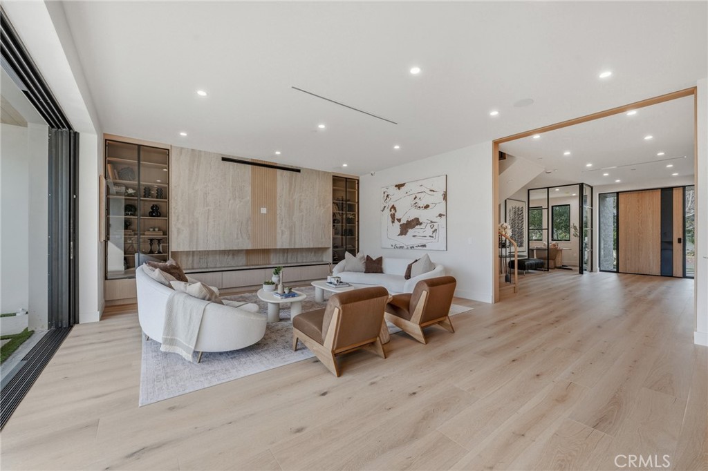 16252 Addison Street Encino, CA 91436 - Photo 5 of 36 a living room with couches and kitchen view with wooden floor