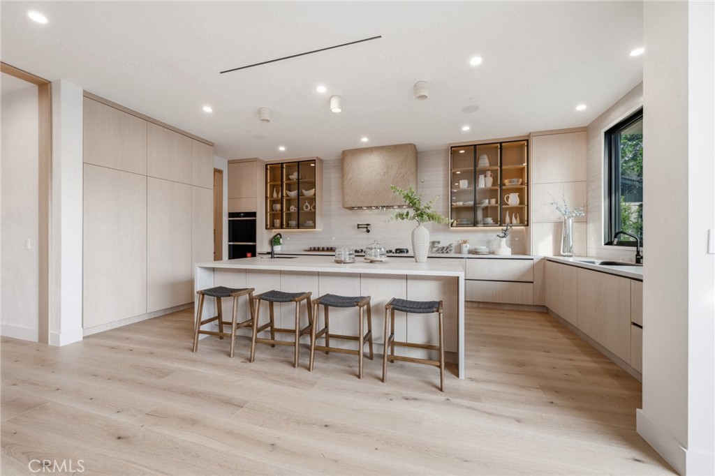 16252 Addison Street Encino, CA 91436 - Photo 7 of 36 a large kitchen with a table and chairs