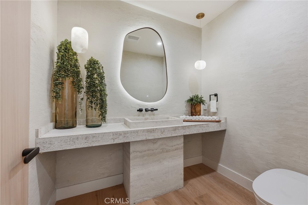 16252 Addison Street Encino, CA 91436 - Photo 8 of 36 a bathroom with a double vanity sink and a mirror