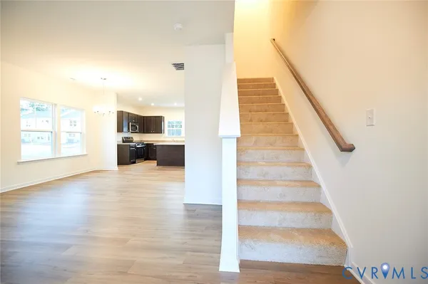 a view of staircase and kitchen with sink