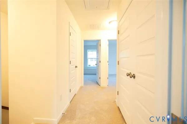 a view of a bathroom from a hallway