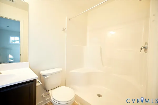 a white toilet sitting next to a bathroom sink