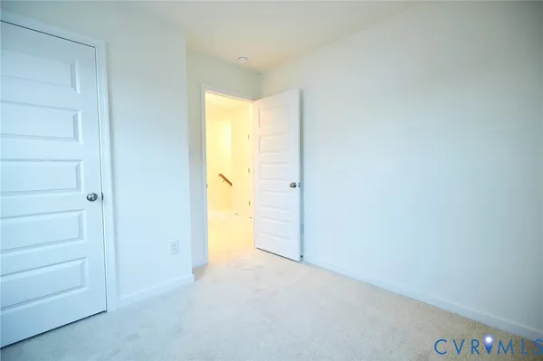 a view of an empty room and a window