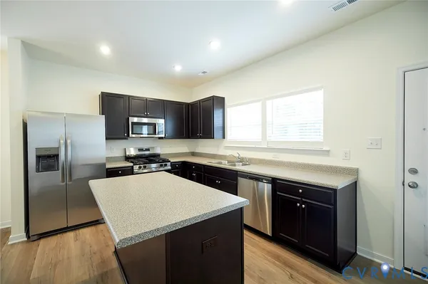 a kitchen with a stove a sink and a refrigerator