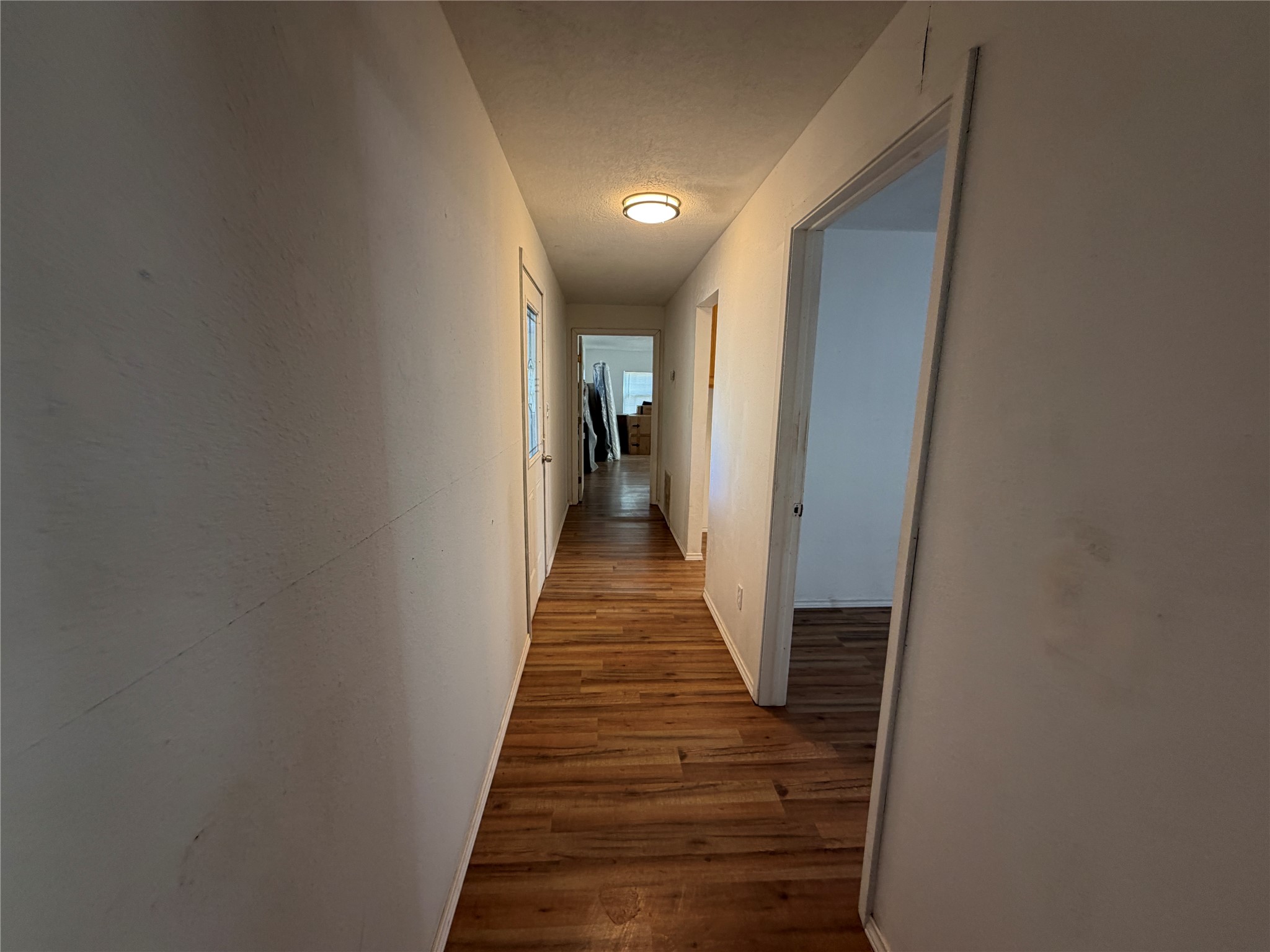 397 County Road 2117 Cleveland, TX 77327 - Photo 15 of 46 a view of a hallway with wooden floor and stairs