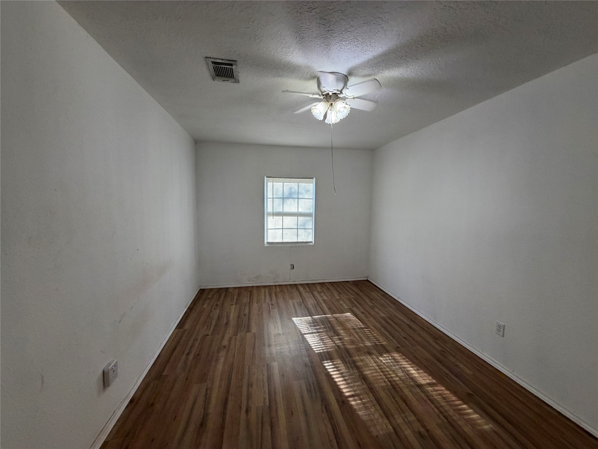 397 County Road 2117 Cleveland, TX 77327 - Photo 16 of 46 wooden floor in an empty room with a window