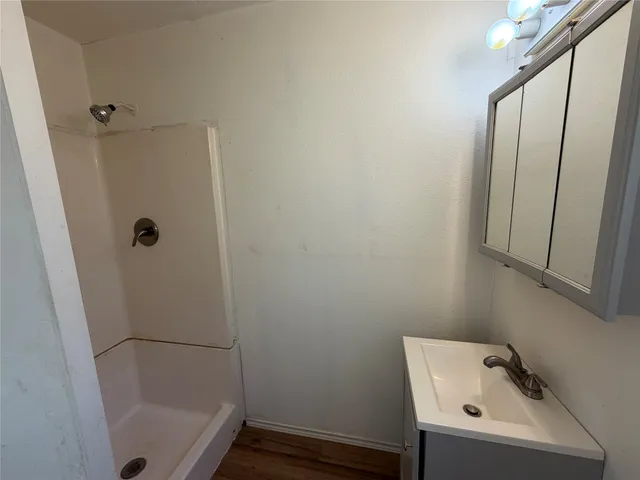 a bathroom with a sink and shower