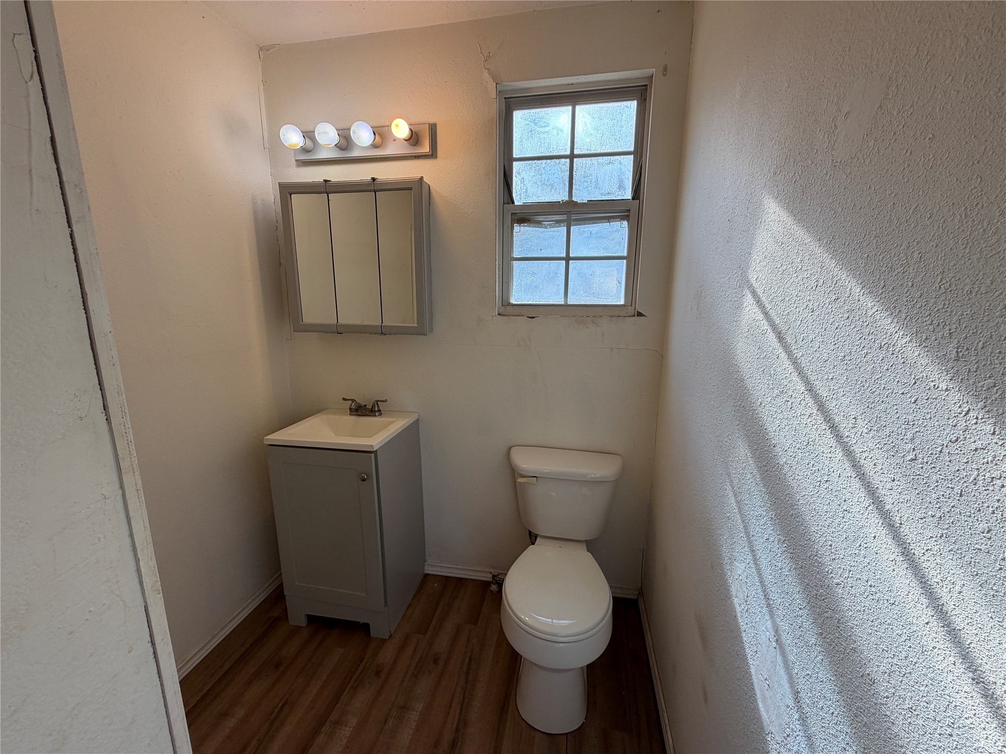 397 County Road 2117 Cleveland, TX 77327 - Photo 19 of 46 a bathroom with a toilet sink and mirror