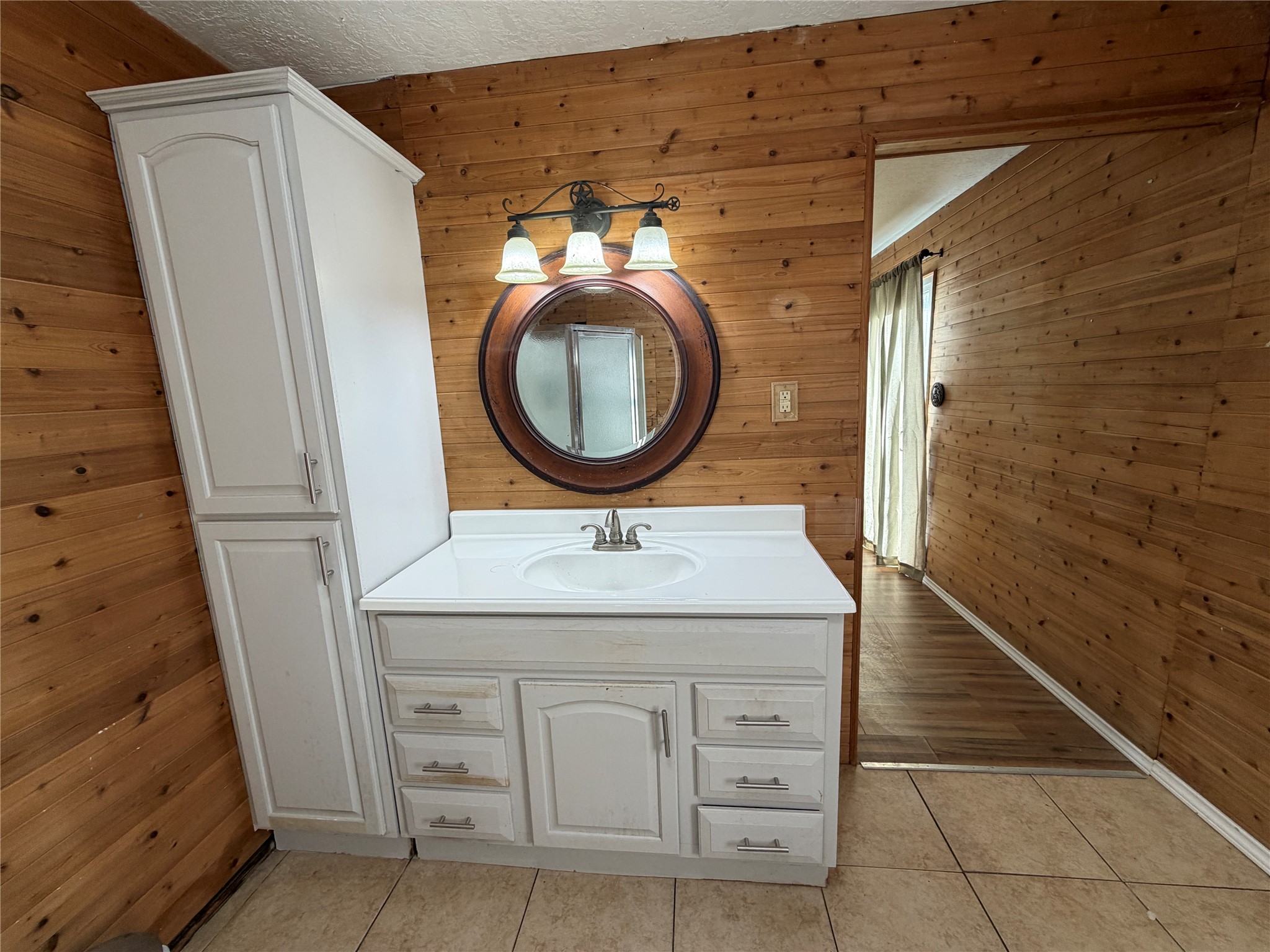 397 County Road 2117 Cleveland, TX 77327 - Photo 24 of 46 a bathroom with a granite countertop sink a vanity and shower