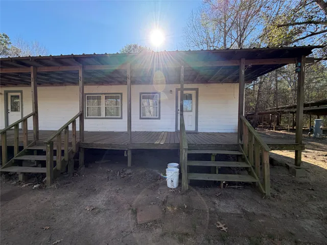 a view of a house with a bed and wooden fence