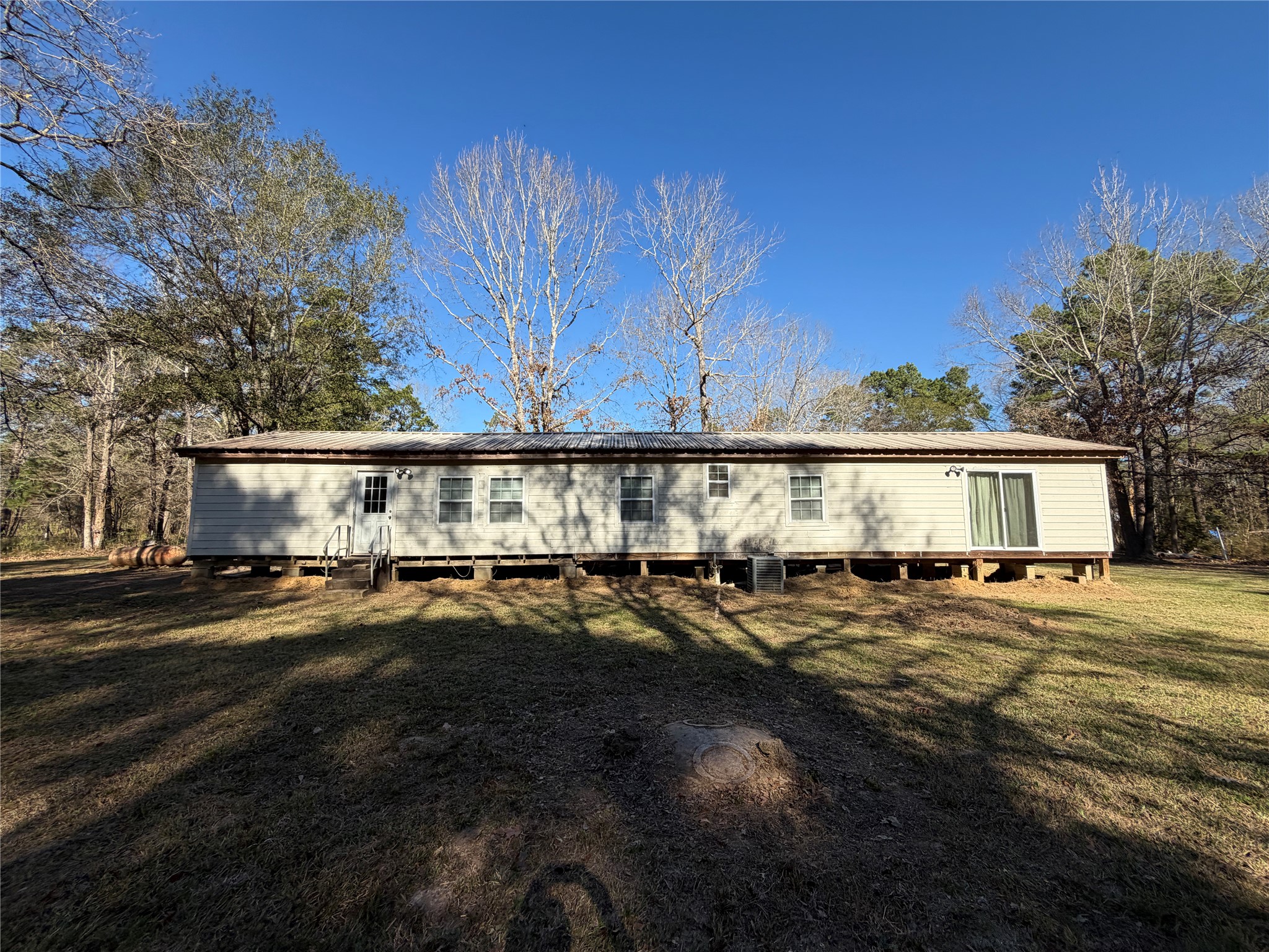 397 County Road 2117 Cleveland, TX 77327 - Photo 39 of 46 a view of a big house with lots of trees and plants