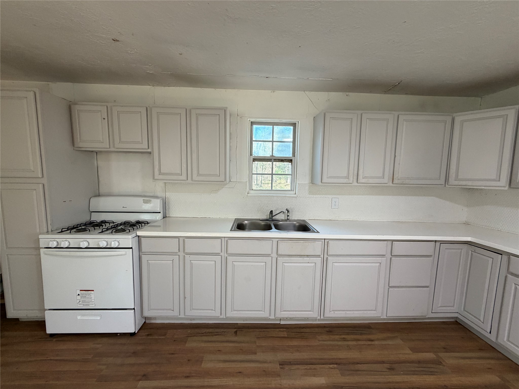 397 County Road 2117 Cleveland, TX 77327 - Photo 7 of 46 a kitchen with stainless steel appliances granite countertop a sink stove and cabinets