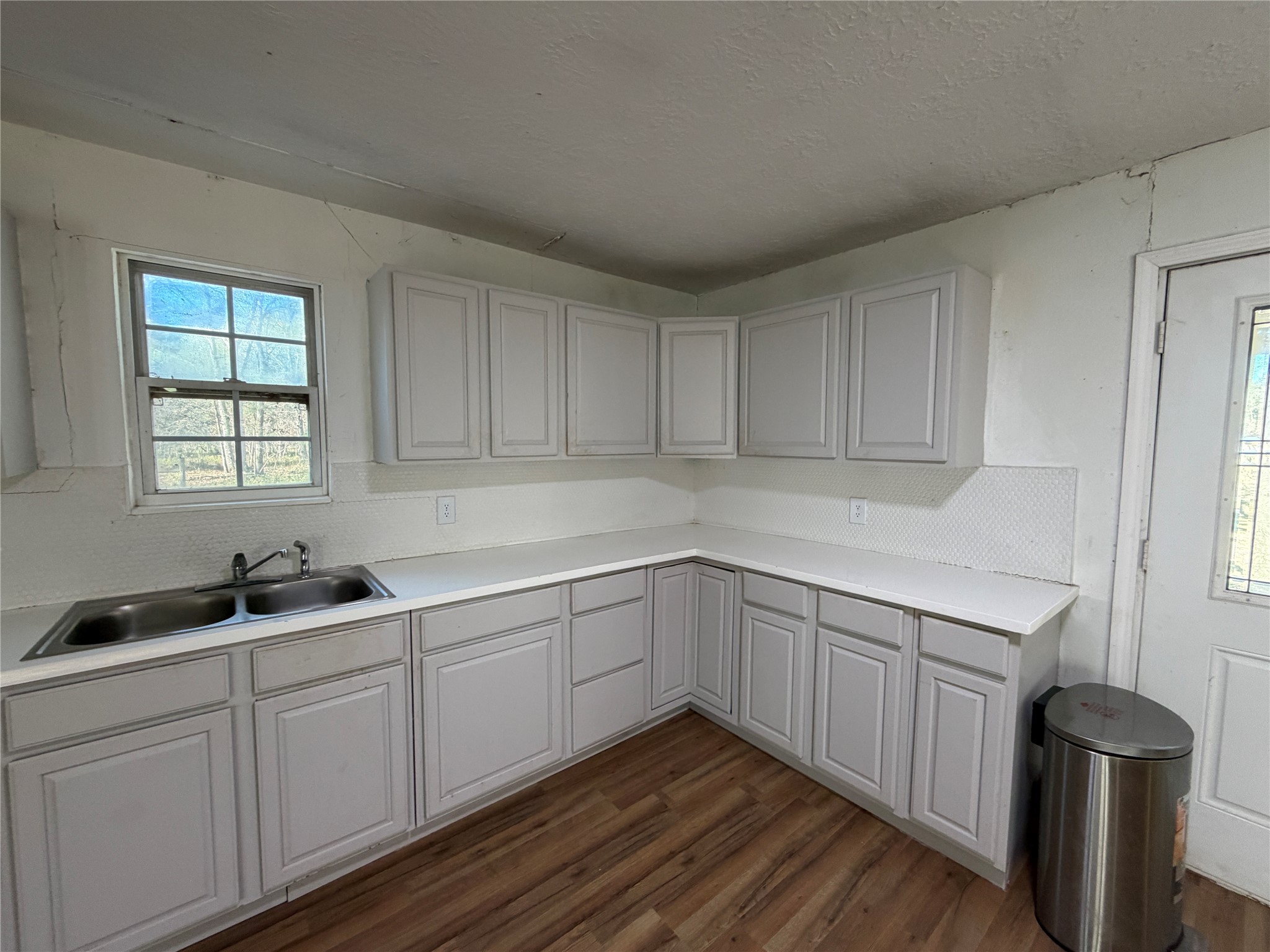 397 County Road 2117 Cleveland, TX 77327 - Photo 8 of 46 a kitchen with a sink and cabinets
