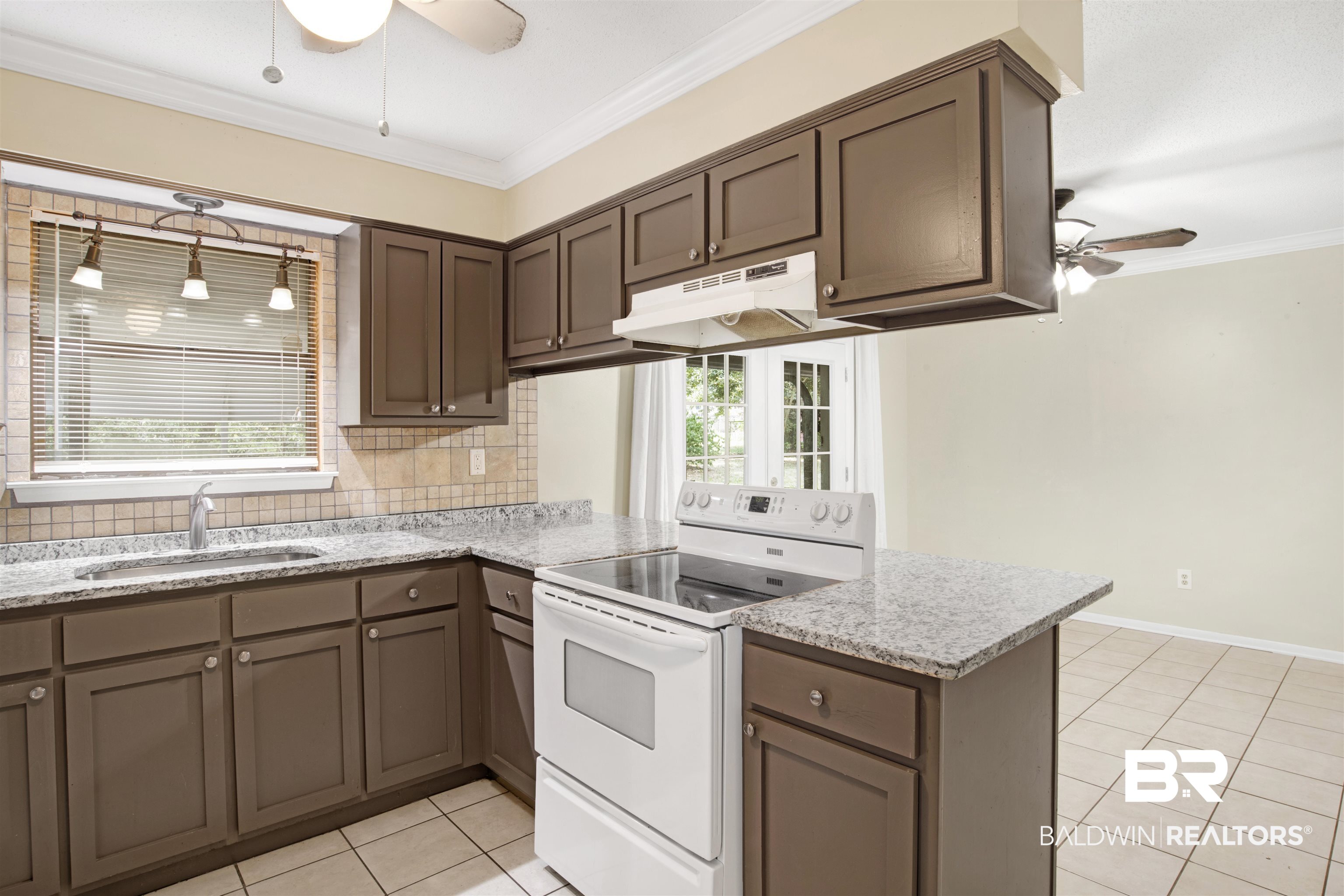 3560 Creekway Road Mobile, AL 36619 - Photo 4 of 24 Kitchen featuring white electric range oven, backsplash, ceiling fan, sink, and kitchen peninsula