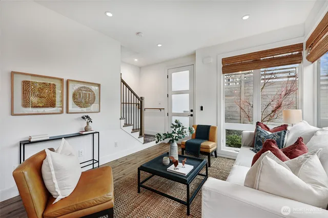 a living room with furniture and a floor to ceiling window
