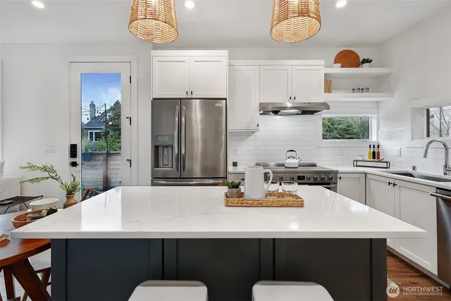 a kitchen with refrigerator and a table