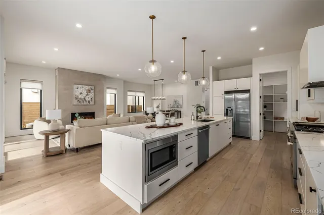 a kitchen with stainless steel appliances kitchen island a large island in the center