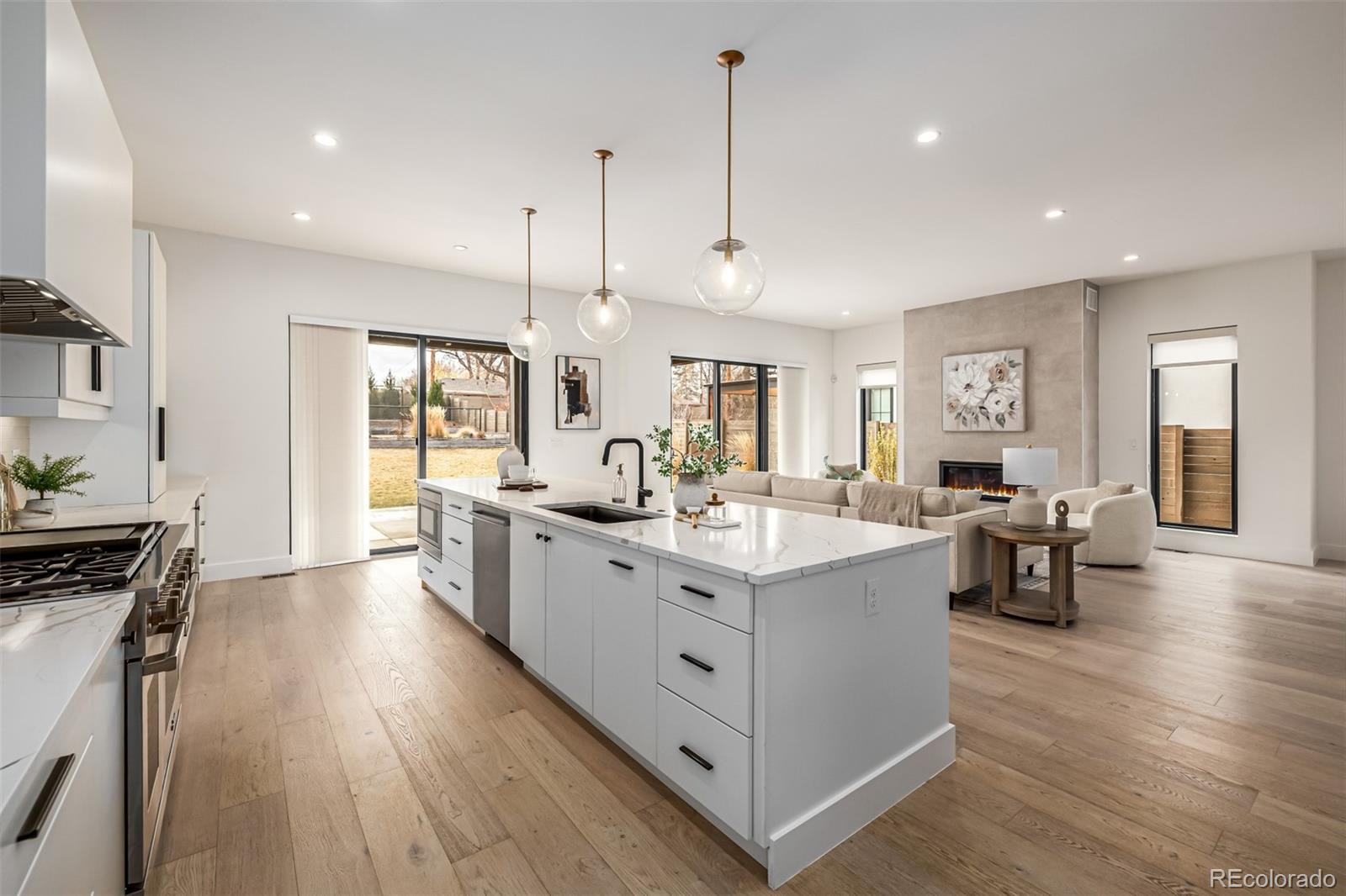5904 West 37th Place Wheat Ridge, CO 80212 - Photo 14 of 50 a large kitchen with stainless steel appliances lots of counter space and a wooden floors