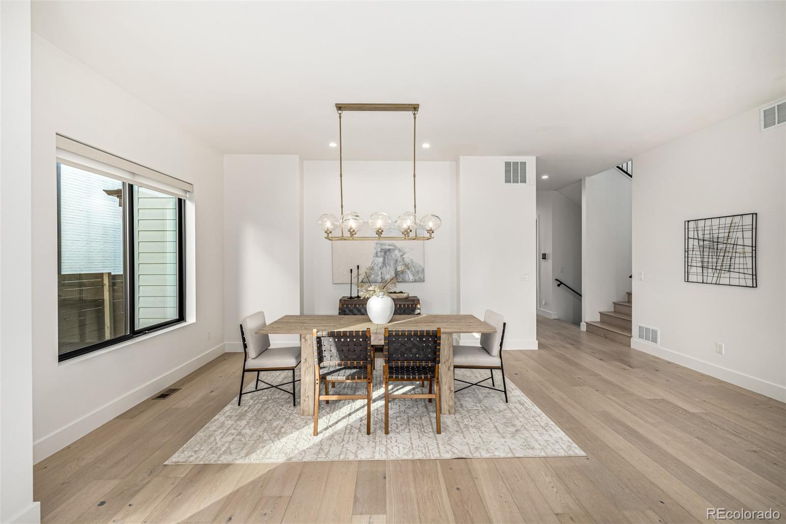 5904 West 37th Place Wheat Ridge, CO 80212 - Photo 16 of 50 a living room with furniture and a wooden floor