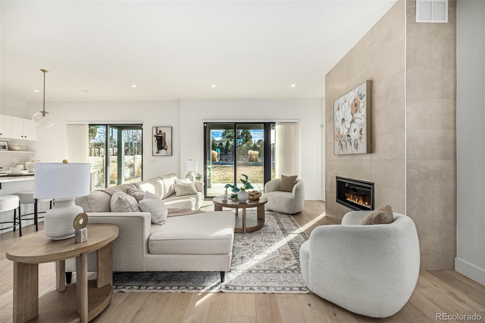 5904 West 37th Place Wheat Ridge, CO 80212 - Photo 2 of 50 a living room with furniture a fireplace and a floor to ceiling window