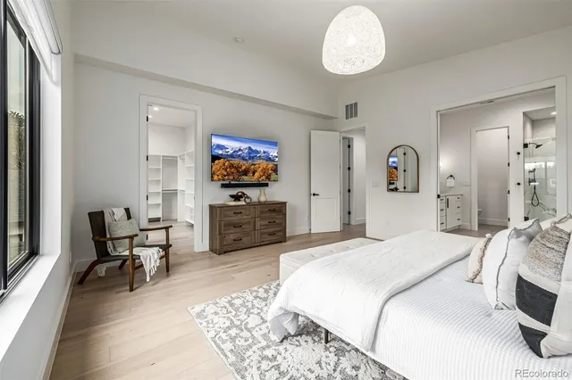 a bathroom with a tub a sink and a large mirror