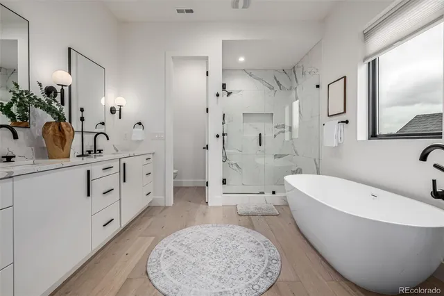 a white bath tub sitting next to a shower