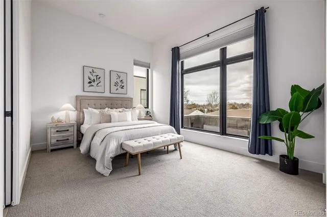 a bedroom with a white bed and a couch