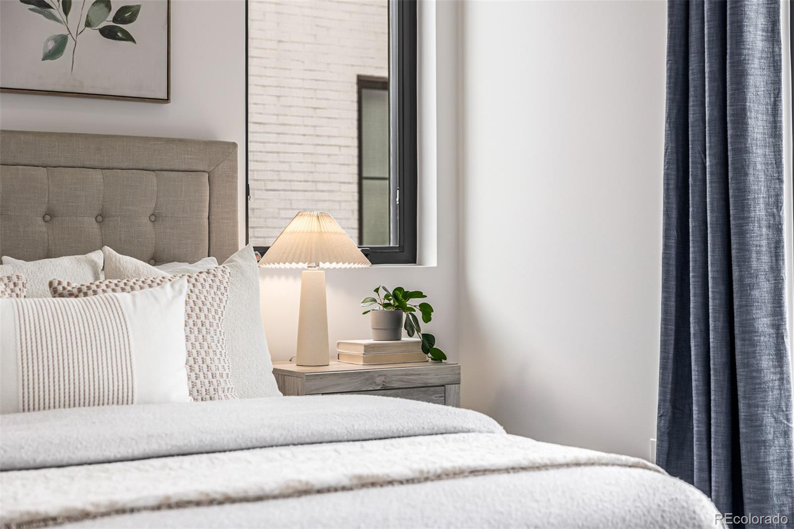 5904 West 37th Place Wheat Ridge, CO 80212 - Photo 27 of 50 a bedroom with a white bed and a couch