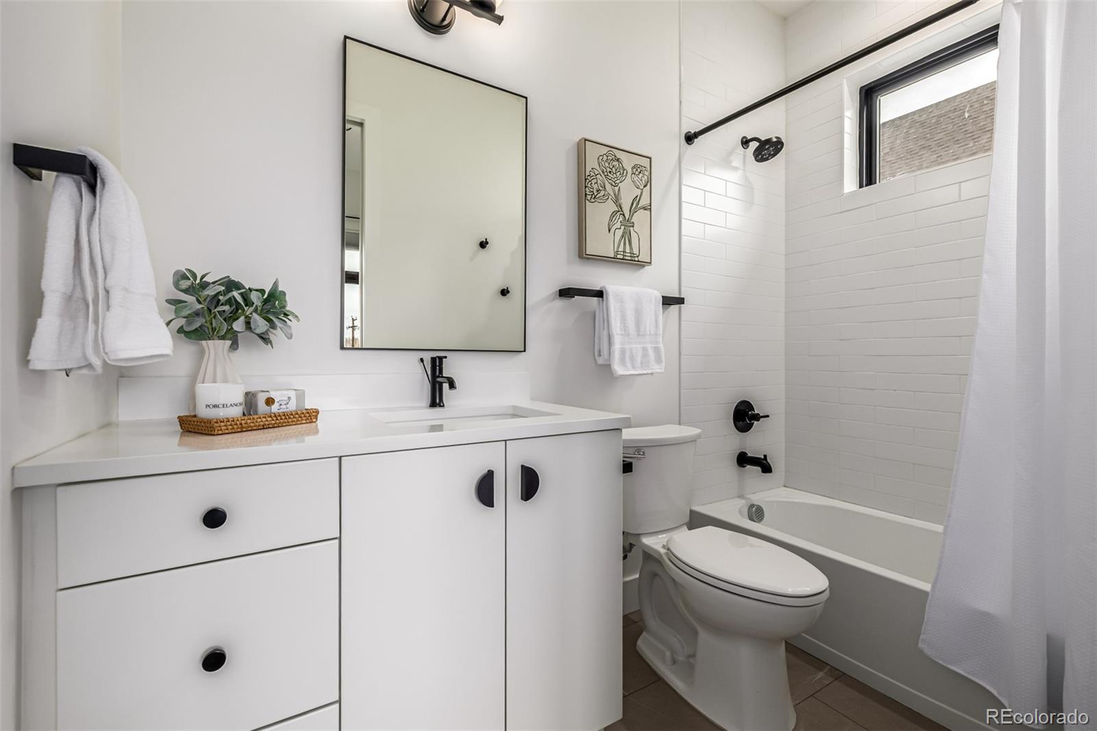 5904 West 37th Place Wheat Ridge, CO 80212 - Photo 28 of 50 a bathroom with a sink a toilet and shower