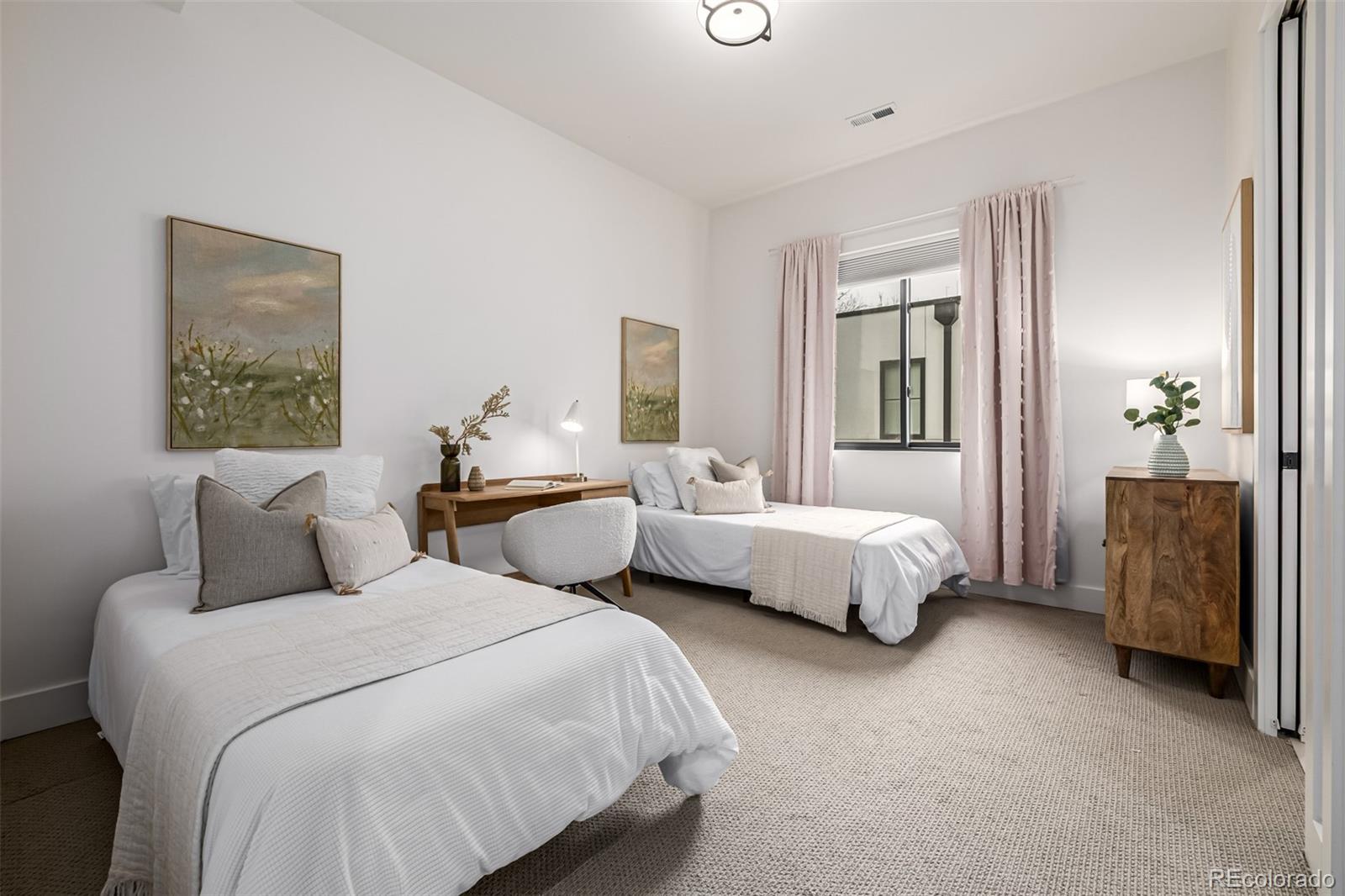 5904 West 37th Place Wheat Ridge, CO 80212 - Photo 29 of 50 a spacious bedroom with two beds and painting on the wall