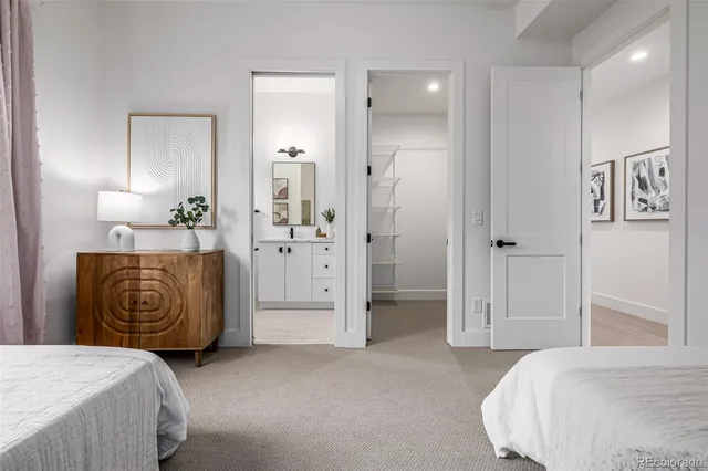 a bathroom with a granite countertop sink toilet a large mirror a shower and a bathtub