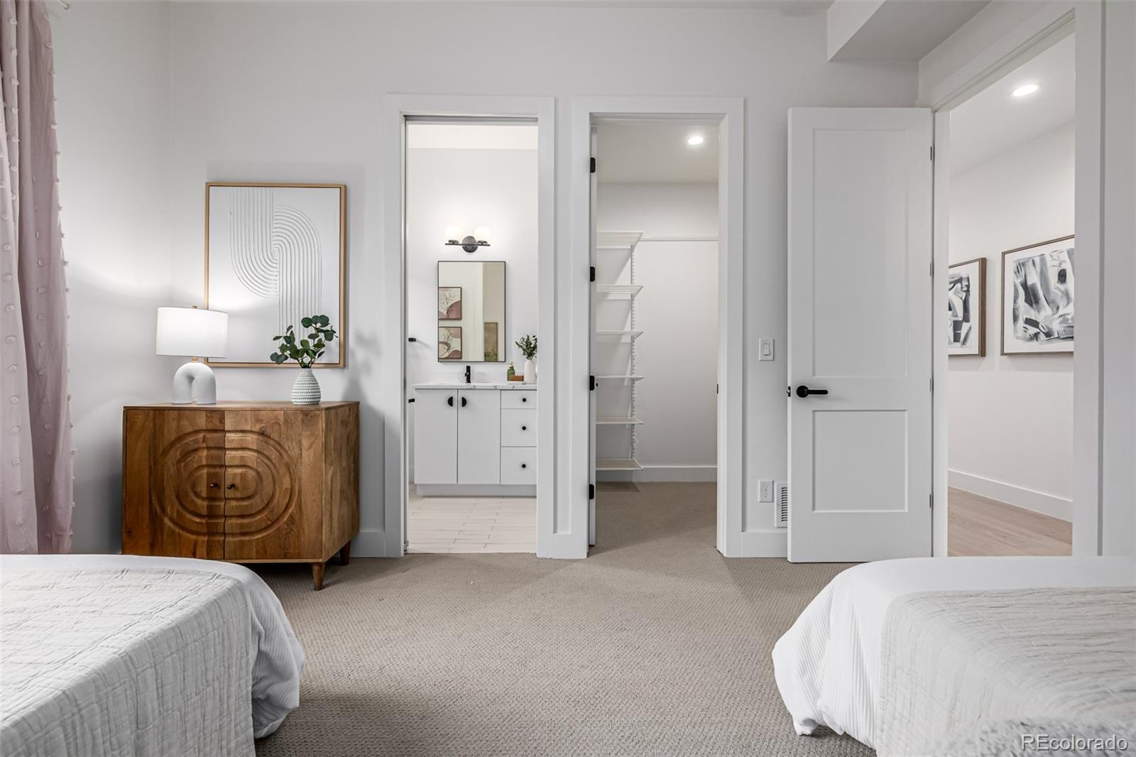 5904 West 37th Place Wheat Ridge, CO 80212 - Photo 30 of 50 a bedroom with a bed and a view of bathroom