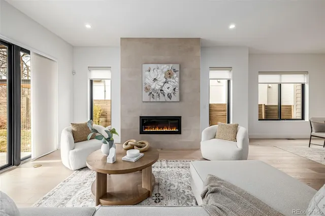 a living room with furniture and a fireplace