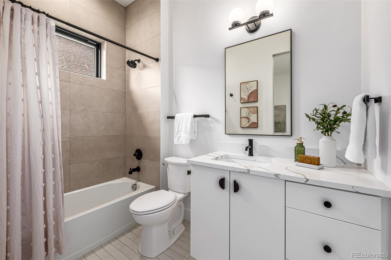 5904 West 37th Place Wheat Ridge, CO 80212 - Photo 31 of 50 a bathroom with a granite countertop sink toilet a large mirror a shower and a bathtub
