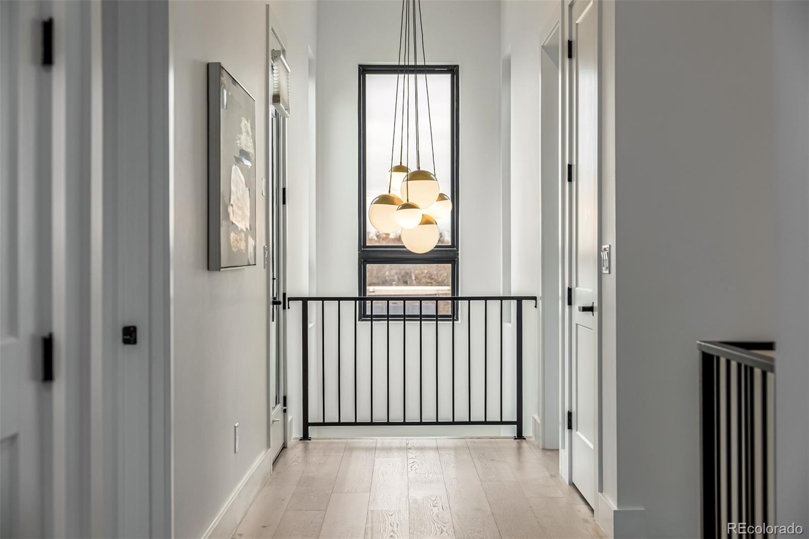 5904 West 37th Place Wheat Ridge, CO 80212 - Photo 32 of 50 a view of a hallway with wooden floor and glass door
