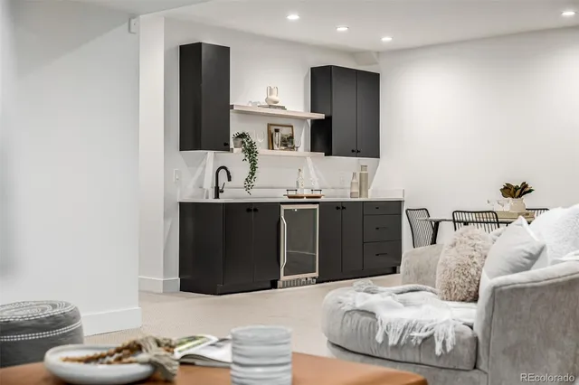 a bedroom with a bed and painting on the wall