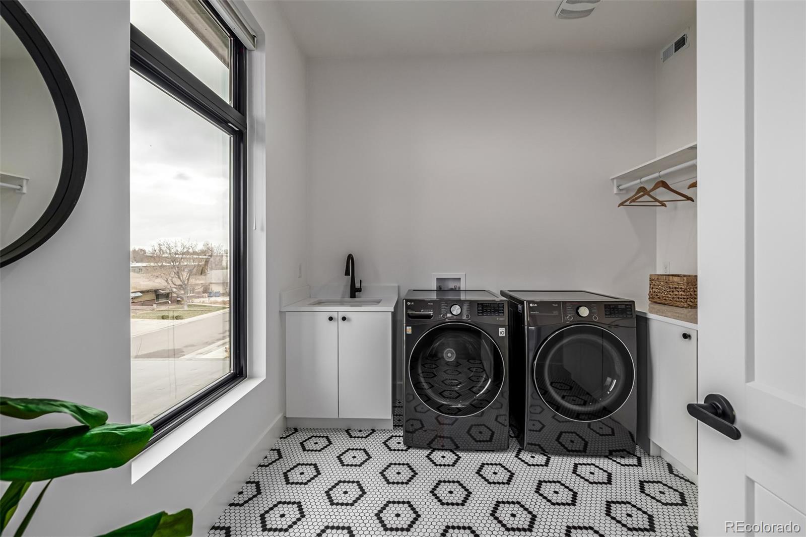 5904 West 37th Place Wheat Ridge, CO 80212 - Photo 41 of 50 a storage room with wooden floor washer and dryer