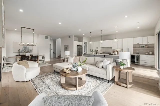 a living room with lots of furniture and kitchen view