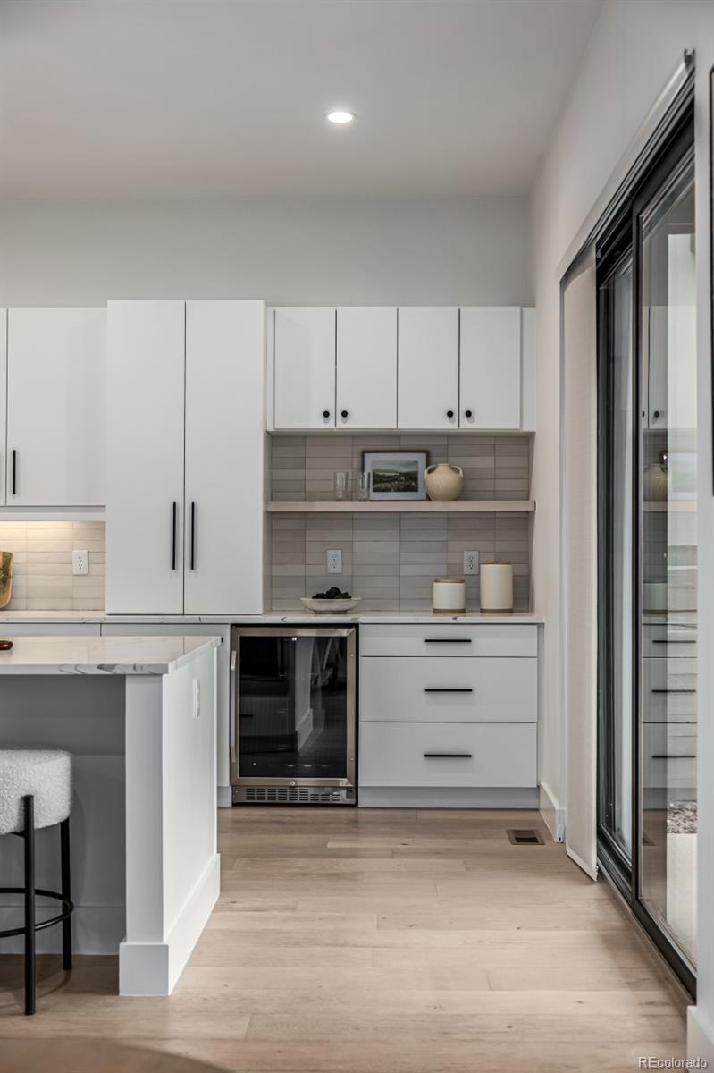 5904 West 37th Place Wheat Ridge, CO 80212 - Photo 8 of 50 a kitchen with stainless steel appliances granite countertop a stove and a refrigerator