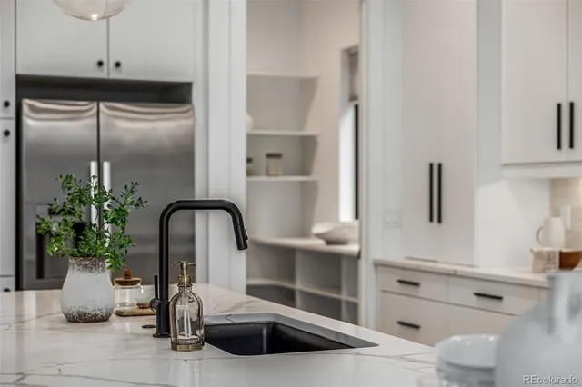 a kitchen with a refrigerator and sink