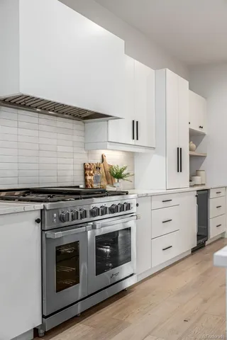 a kitchen with stainless steel appliances granite countertop a stove and a sink