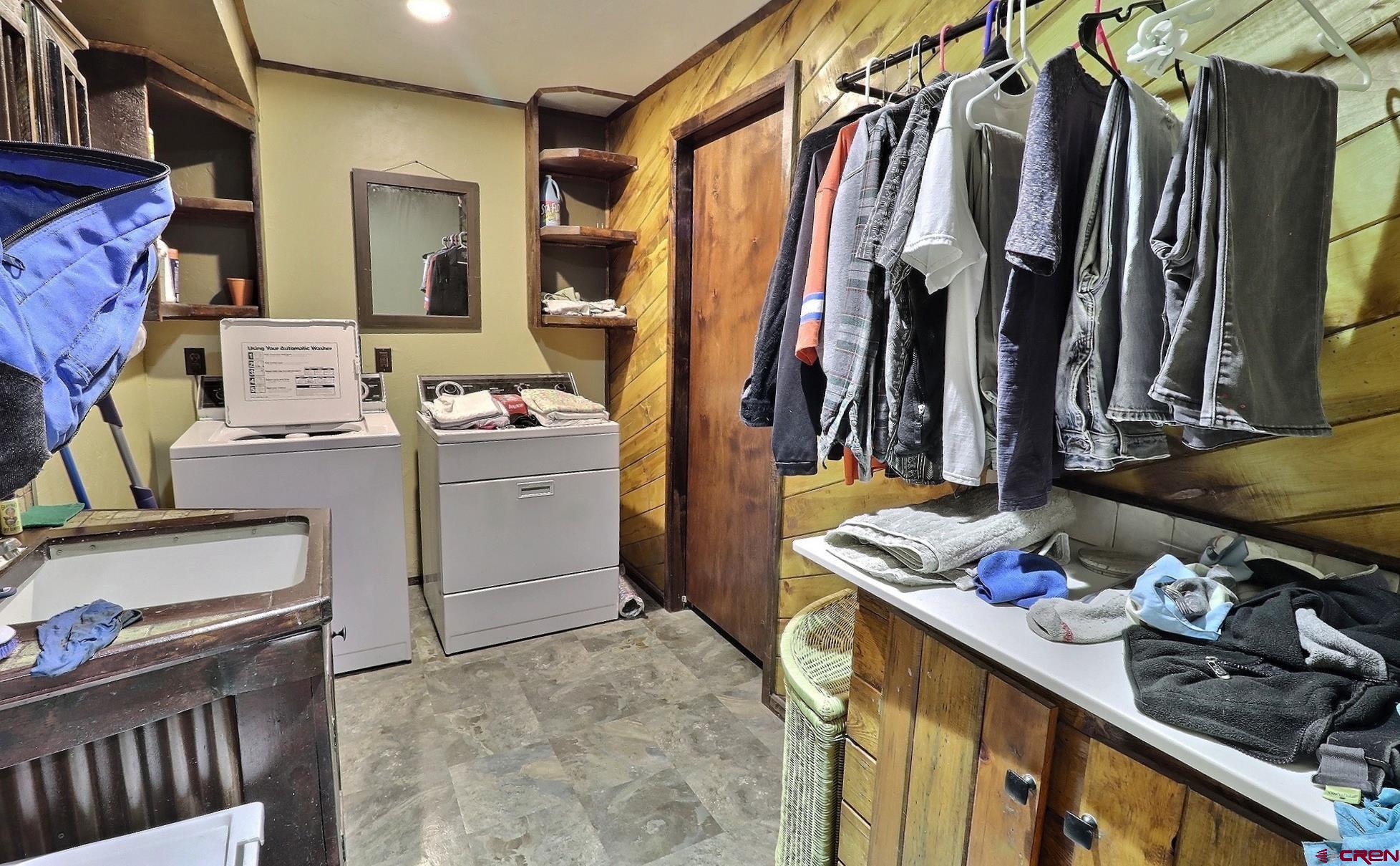 16511 Rimrock Road Cedaredge, CO 81413 - Photo 26 of 35 a view of walk in closet with clothes and shoes