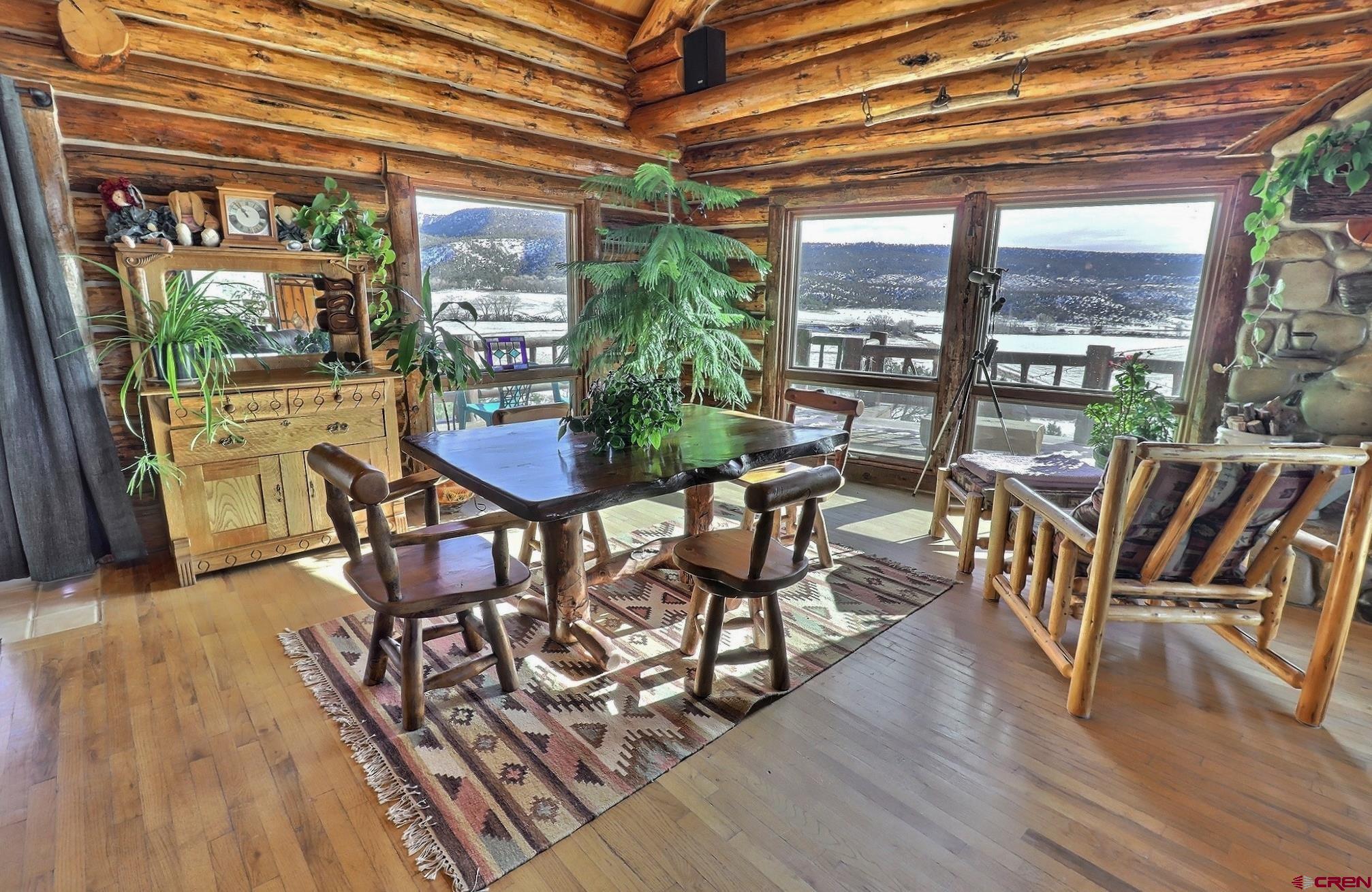 16511 Rimrock Road Cedaredge, CO 81413 - Photo 3 of 35 a view of a dining room with furniture and wooden floor